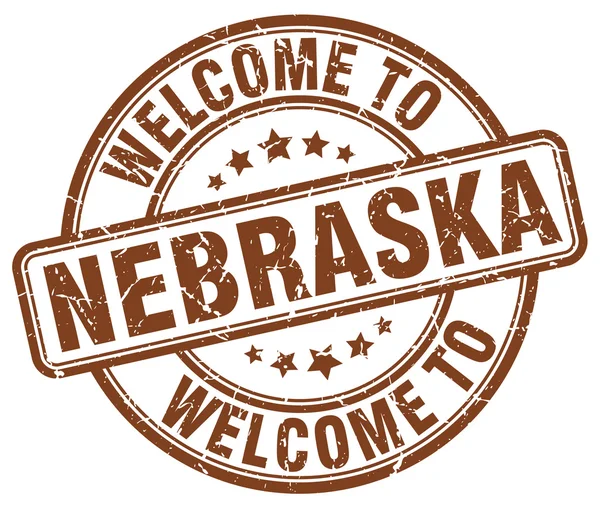 Benvenuto a Nebraska marrone rotondo timbro vintage — Vettoriale Stock