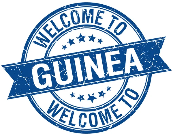 Benvenuto a Guinea timbro nastro rotondo blu — Vettoriale Stock