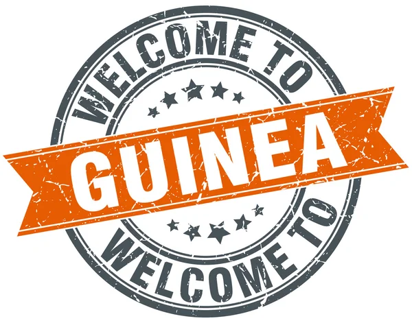 Benvenuto a Guinea arancione nastro rotondo timbro — Vettoriale Stock