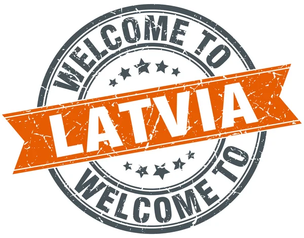 Selamat datang di Latvia oranye bulat cap pita - Stok Vektor