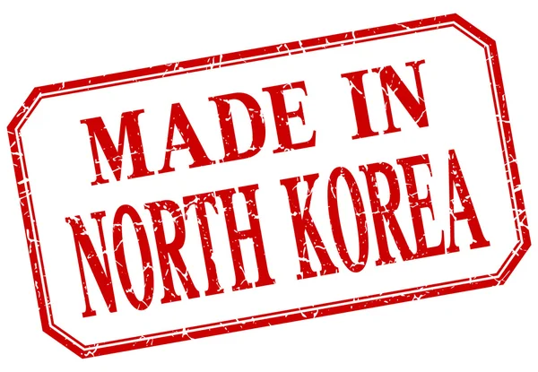 Coreia do Norte - feito em etiqueta isolada vintage vermelho — Vetor de Stock