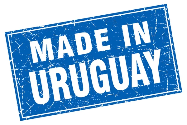 Grunge carré bleu Uruguay fabriqué en timbre — Image vectorielle