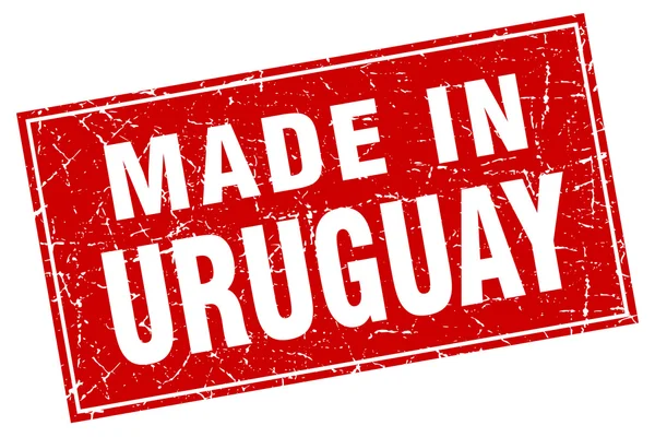 Grunge carré rouge Uruguay fabriqué en timbre — Image vectorielle