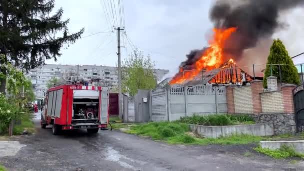 Le toit de la maison est en feu. Le bâtiment résidentiel brûle, village. — Video