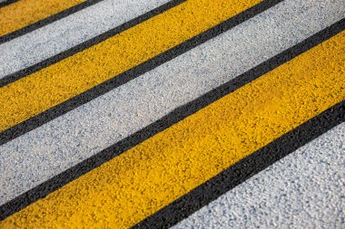 Güneş ışınlarında asfalt bir yolda yaya geçidi..