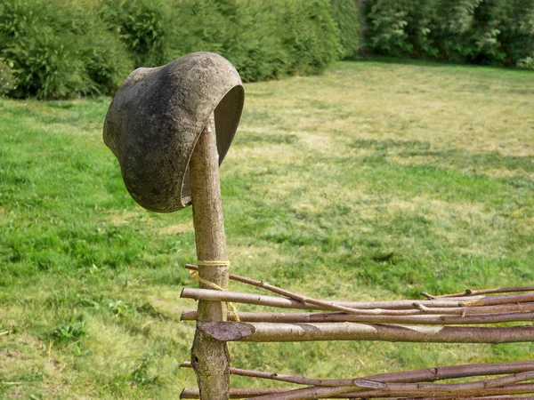 Pot on wicker fence — Stock Photo, Image