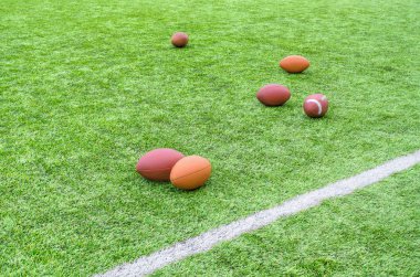 Rugby balls on field clipart