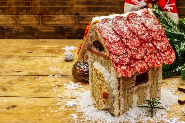 Şarküteri köşkü ya da Noel 'in en yeni yemek modası olarak Et Kulübesi. Geleneksel dekoru ve sembolleri olan yeni yıl keto kurabiyesi evi. Beyaz kar arkaplanı, kopyalama alanı