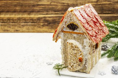 Şarküteri köşkü ya da Noel 'in en yeni yemek modası olarak Et Kulübesi. Geleneksel dekoru ve sembolleri olan yeni yıl keto kurabiyesi evi. Beyaz kar arkaplanı, kopyalama alanı