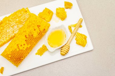 Bal peteği, bal ve balmumu. Sağlıklı ve güzel bir yaşam tarzı için doğal organik arıcılık ürünleri. Taş beton arkaplan, kopyalama alanı