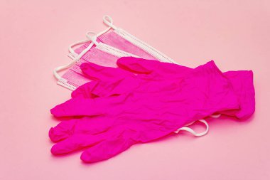 Fashion masks and glamour gloves isolated on pink background. Medical products for personal hygiene and the prevention of viral diseases. Coronavirus, COVID-19 pandemic, 2019-nCoV worldwide concept