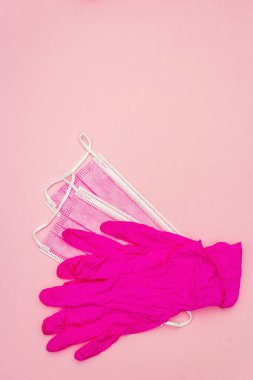 Fashion masks and glamour gloves isolated on pink background. Medical products for personal hygiene and the prevention of viral diseases. Coronavirus, COVID-19 pandemic, 2019-nCoV worldwide concept