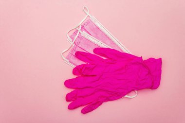 Fashion masks and glamour gloves isolated on pink background. Medical products for personal hygiene and the prevention of viral diseases. Coronavirus, COVID-19 pandemic, 2019-nCoV worldwide concept