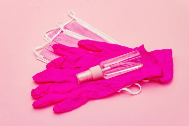 Fashion masks, glamour gloves and sanitizer isolated on pink background. Medical products for personal hygiene and the prevention of viral diseases. Coronavirus, COVID-19 pandemic, 2019-nCoV worldwide concept