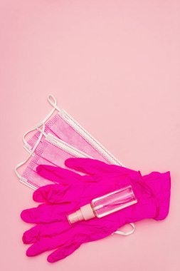 Fashion masks, glamour gloves and sanitizer isolated on pink background. Medical products for personal hygiene and the prevention of viral diseases. Coronavirus, COVID-19 pandemic, 2019-nCoV worldwide concept