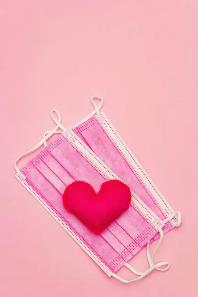 Red Heart Medical Protection Mask Light Pink Background Top View — Stockfoto