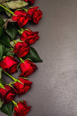 Siyah taştan bir arka planda bir buket taze bordo gül. Kokulu kırmızı çiçekler, Sevgililer Günü için hediye konsepti, düğün ya da doğum günü