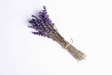 Beyaz arkaplanda kuru lavanta buketi var. Aromatik çiçekler, geleneksel gıda ve kozmetik malzemeleri.