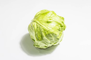 Taze taze lahana, tüm kafa beyaz arka planda izole edilmiş. Modern sert ışık, karanlık gölge. Bahar salatası kesmek için sebzeler. Vejetaryen yemeği, diyet, vitamin