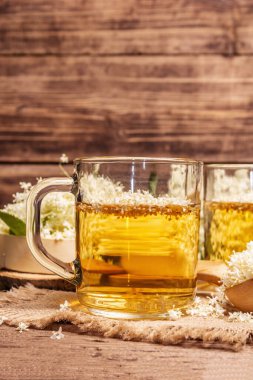 Mürver çiçeği çayı. Taze yaz içkisi, sağlıklı yaşam tarzı konsepti. Kumaş peçete, eski ahşap masa, kapatın.