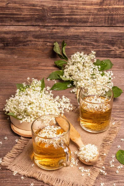 Mürver çiçeği çayı. Taze yaz içkisi, sağlıklı yaşam tarzı konsepti. Kumaş peçete, eski ahşap masa, kopyalama alanı