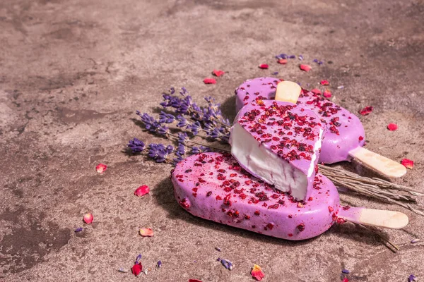 Lavender ice cream. Flower bouquet, pink rose petals. Trendy hard light, dark shadow. Marble stone background, copy space, flat lay