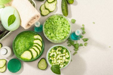 Salatalıklı ev yapımı kozmetik ürünleri. Deri deoksifikasyonu sebze maskeleri. Doğal krem, deniz tuzu, vücut losyonu ve sabun. Modern sert ışık, karanlık gölge. Taş beton zemin, üst görünüm