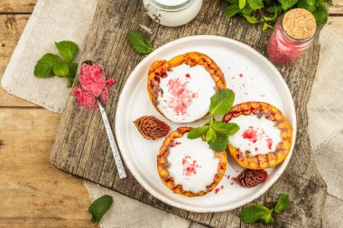 Yoğurtlu ızgara şeftali, nane ve tatlı pembe şeker. Yararlı kahvaltı konsepti, sağlıklı yemek. Eski ahşap zemin, üst manzara