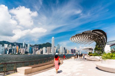 Tourists visiting the Avenue of the Stars. The Avenue of Stars is located along the Victoria Harbor in Hong Kong. clipart