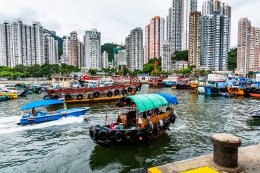 Traditional fishing trawler in the Aberdeen Bay. Famous floating village in Aberdeen is an area and town on the south shore of Hong Kong Island clipart