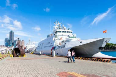 Turistler, Tayvan 'ın Kaohsiung limanındaki Pier-2 Sanat Merkezi' ni, Tayvan Sahil Güvenlik devriye gemileri ve kurulum sanatı ile ziyaret ediyorlar..