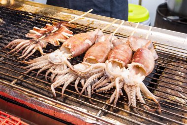 Tayvan gece pazarında ızgarada bir sürü kalamar şişi var..