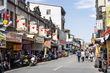 Kaohsiung, Tayvan - 2 Nisan 2024: Kaohsiung, Tayvan 'daki Kaishan (Cishan) Eski Sokak Ticaret Bölgesi' ni ziyaret eden turistler. Taiwan 'ın Japon hakimiyeti sırasında Barok tarzı binalar..
