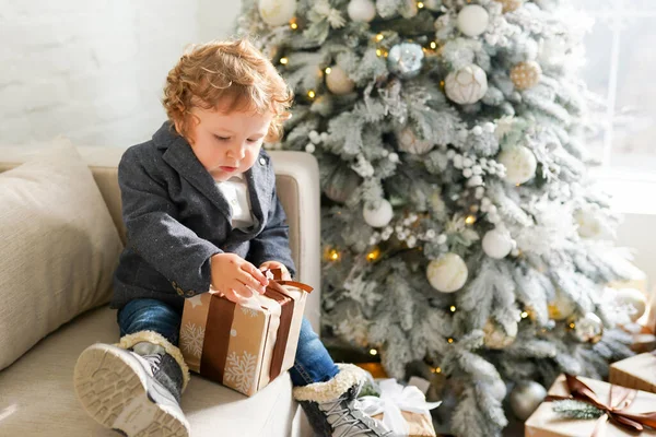 Little Child Men Suit Sits Gray Sofa Christmas Tree Opens — Stock Photo, Image