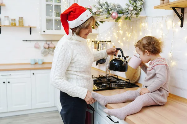 Happy Grandmother Granddaughter Drinking Tea Christmas Kitchen — Stock Photo, Image