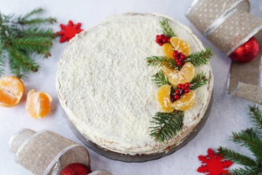 Gri arka planda kış süslemeleri olan Noel pastası