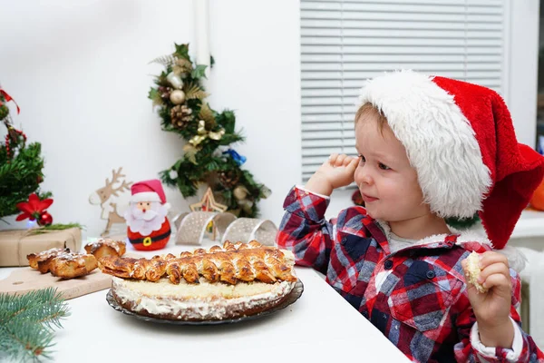 Happy Funny Little Girl Santa Hat Eats Christmas Cake Home — Stock Photo, Image
