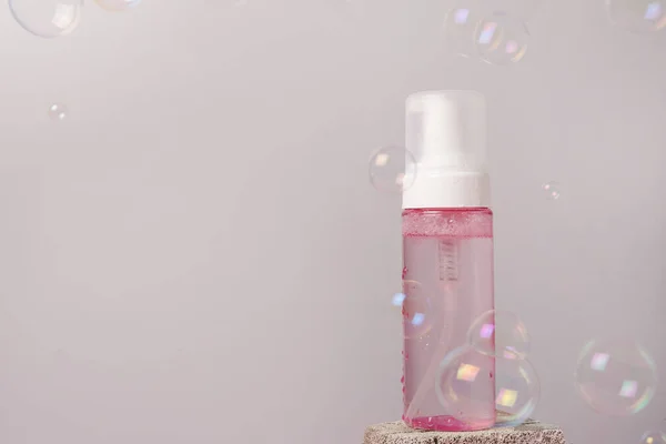 Ροζ Όμορφο Μπουκάλι Υγρό Καθαρισμού Φυσαλίδες Που Παραμένουν Στην Πέτρα — Φωτογραφία Αρχείου