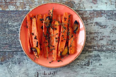 Fırında havuç tabağı. Baharatlı ve otlu fırında havuç. Vejetaryen yemeği. Sağlıklı yiyecekler. Çevre yemeği. Evde sağlıklı yemek pişirmek..
