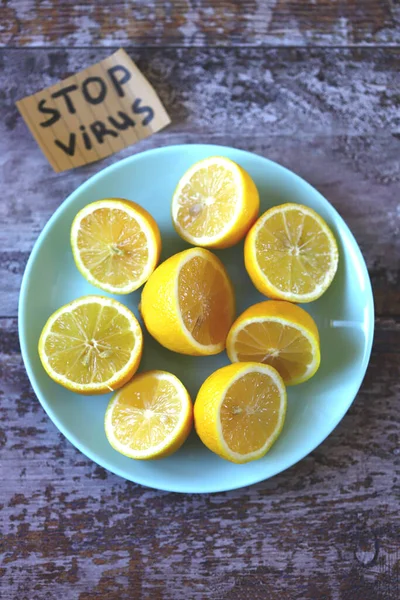 Stop virus concept. Plate with lemons and a note stop virus. The concept of antiviral products that enhance immunity.