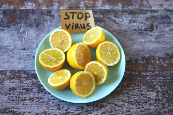 Stop virus concept. Plate with lemons and a note stop virus. The concept of antiviral products that enhance immunity.