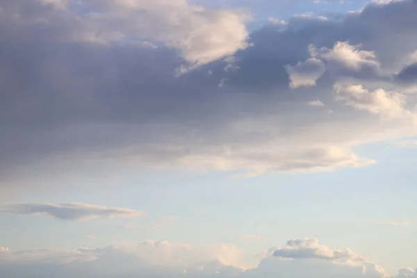 Fluffy clouds of the spring sky. Cold sky with clouds.