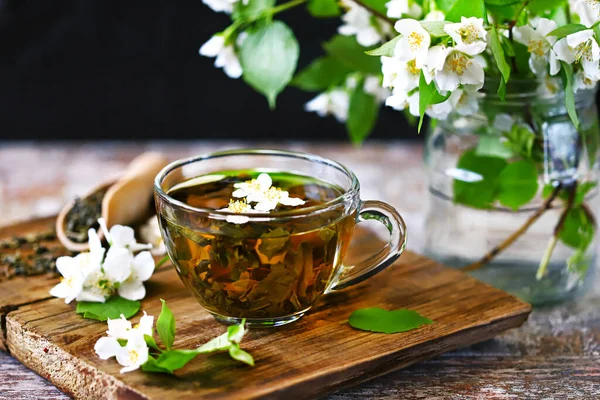 Fresh jasmine tea in a cup with jasmine flowers.