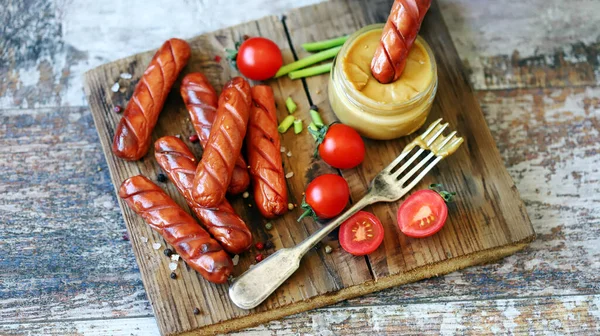 Appetizing fried sausages with mustard. German sausages. Snack for beer.