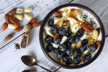 Cottage cheese and yogurt bowl with nuts and blueberries