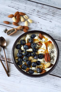 Cottage cheese and yogurt bowl with nuts and blueberries
