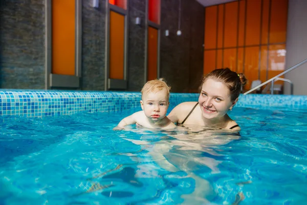 Mother with child in pool