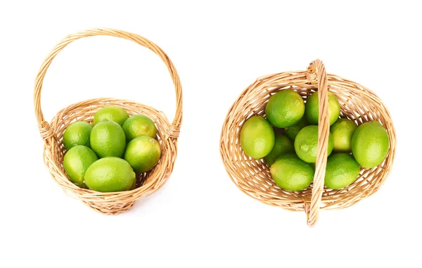Wicker basket full of multiple ripe limes, composition isolated over the white background, set of two different foreshortenings — Stock Photo, Image