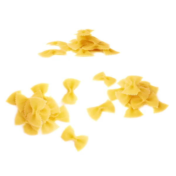 Pile of dry farfalle pasta over isolated white background — Stock Photo, Image