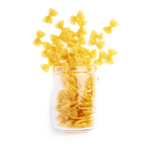 Glass jar filled with dry farfalle pasta over isolated white background — Stock Photo, Image